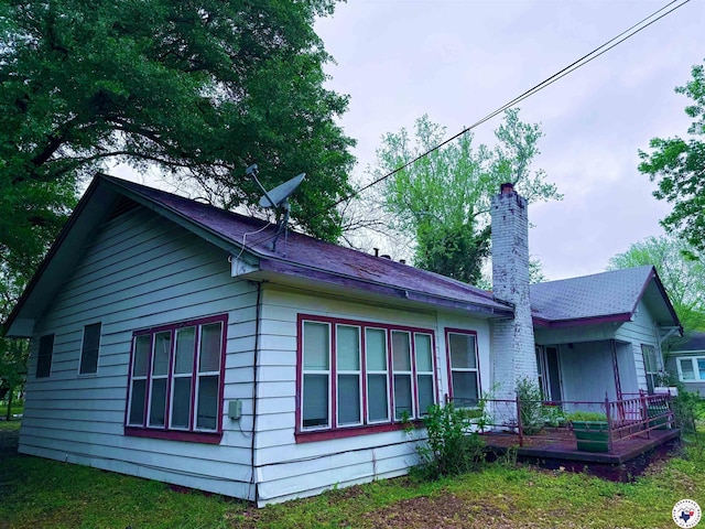 view of side of property featuring a chimney
