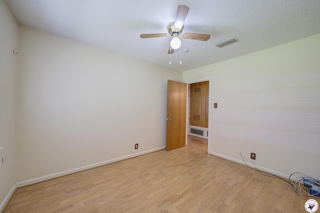 814 Hawkins Ave, Wake Village, TX 75501 - empty room with light wood-style flooring, baseboards, ceiling fan, and a textured ceiling