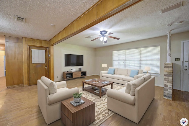 814 Hawkins Ave, Wake Village, TX 75501 - living area with a textured ceiling, light wood-style floors, and ceiling fan