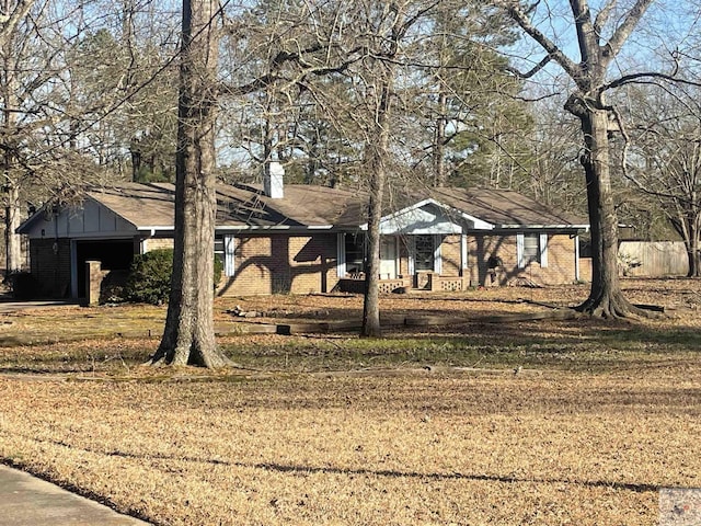 view of front of home featuring brick siding, a front lawn, and a chimney