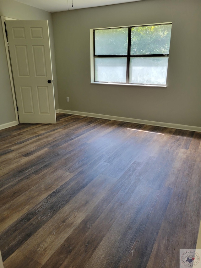 unfurnished room with dark hardwood / wood-style floors