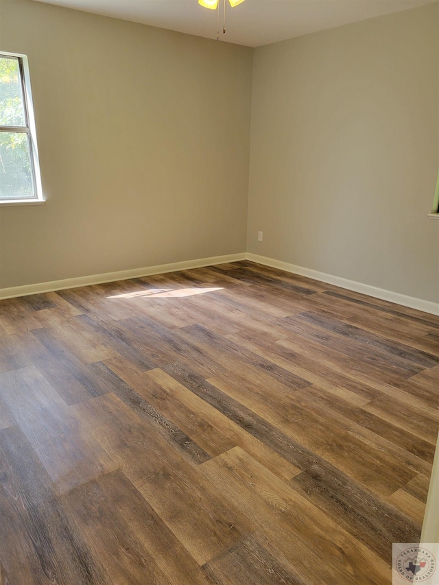 unfurnished room featuring ceiling fan and dark hardwood / wood-style flooring