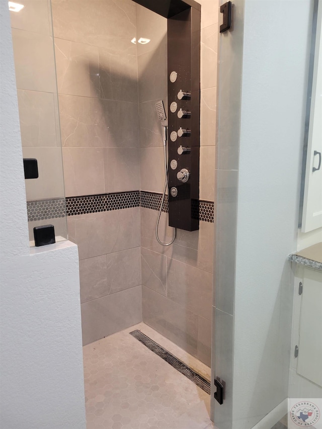 bathroom with a tile shower