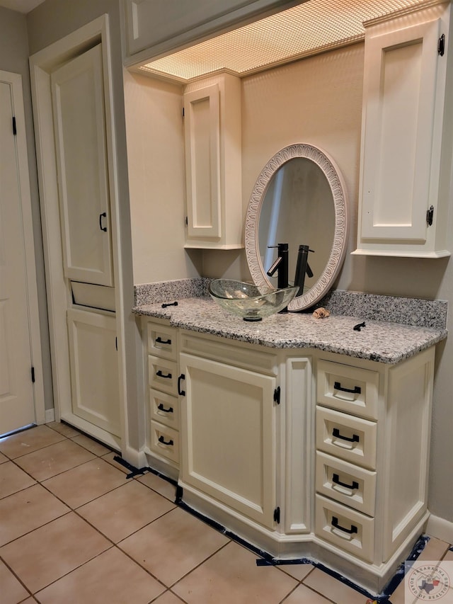 bathroom with tile patterned floors and vanity