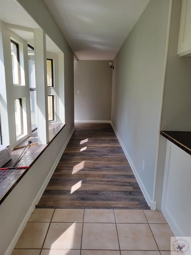 hall with light tile patterned floors