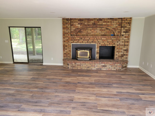 unfurnished living room with hardwood / wood-style floors and crown molding