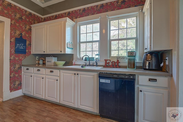 kitchen with crown molding, dishwasher, sink, white cabinets, and light wood-type flooring