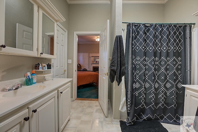 bathroom with vanity, crown molding, and a shower with curtain