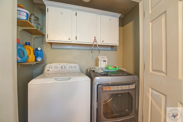 laundry room with cabinets and washing machine and dryer