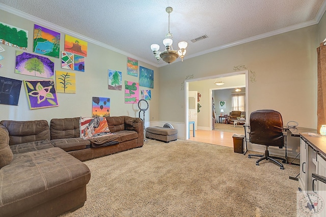 living room featuring a textured ceiling, ornamental molding, a chandelier, and carpet flooring