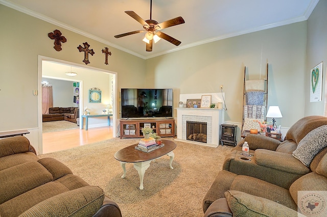 carpeted living room featuring crown molding and ceiling fan