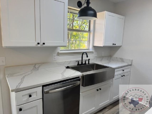 kitchen featuring dishwasher, sink, decorative light fixtures, white cabinetry, and light stone countertops