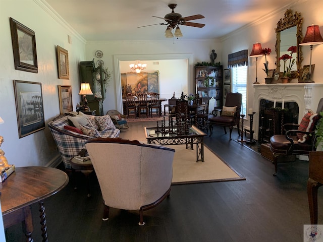 living room featuring a premium fireplace, ceiling fan with notable chandelier, ornamental molding, and dark wood-type flooring