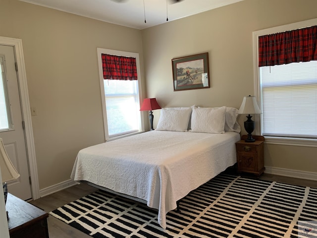 bedroom with dark hardwood / wood-style floors