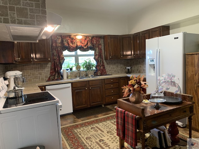 kitchen with dark brown cabinets, sink, tasteful backsplash, exhaust hood, and white appliances