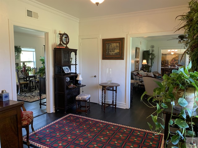 interior space with crown molding and dark wood-type flooring