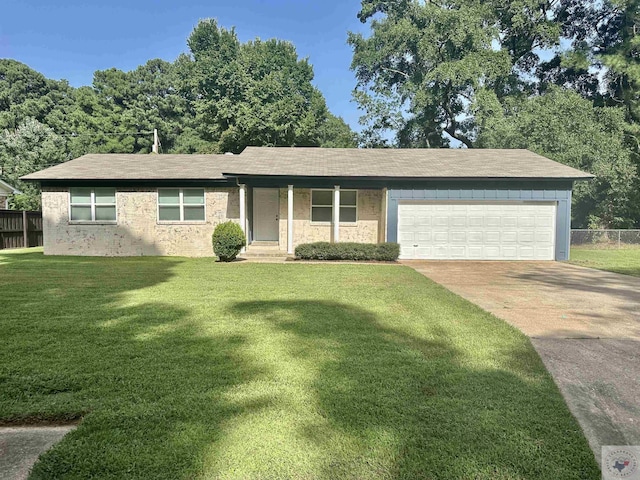 ranch-style home with a garage and a front yard