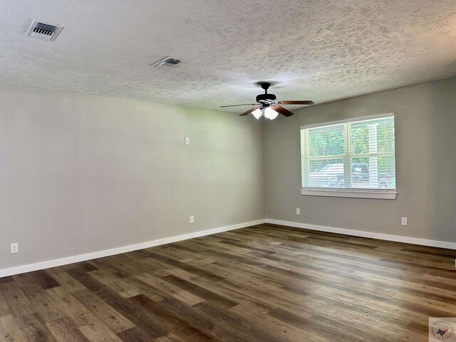 spare room with ceiling fan, dark hardwood / wood-style floors, and a textured ceiling