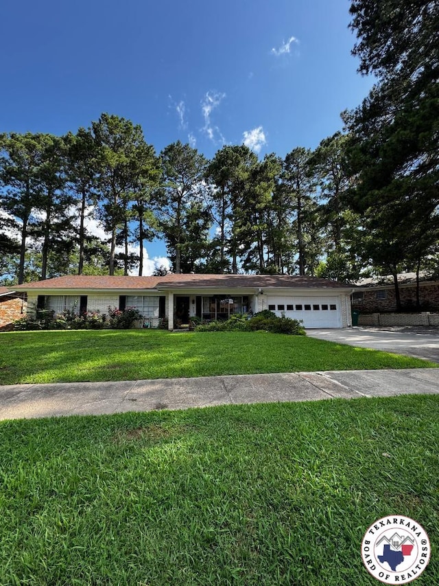 1509 W 40th St, Texarkana, TX 75503 - ranch-style house featuring driveway, a front yard, and an attached garage