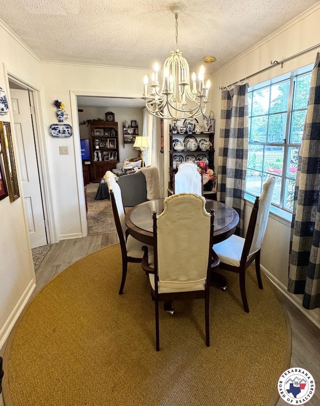 1509 W 40th St, Texarkana, TX 75503 - dining area with crown molding, a chandelier, a textured ceiling, and wood finished floors