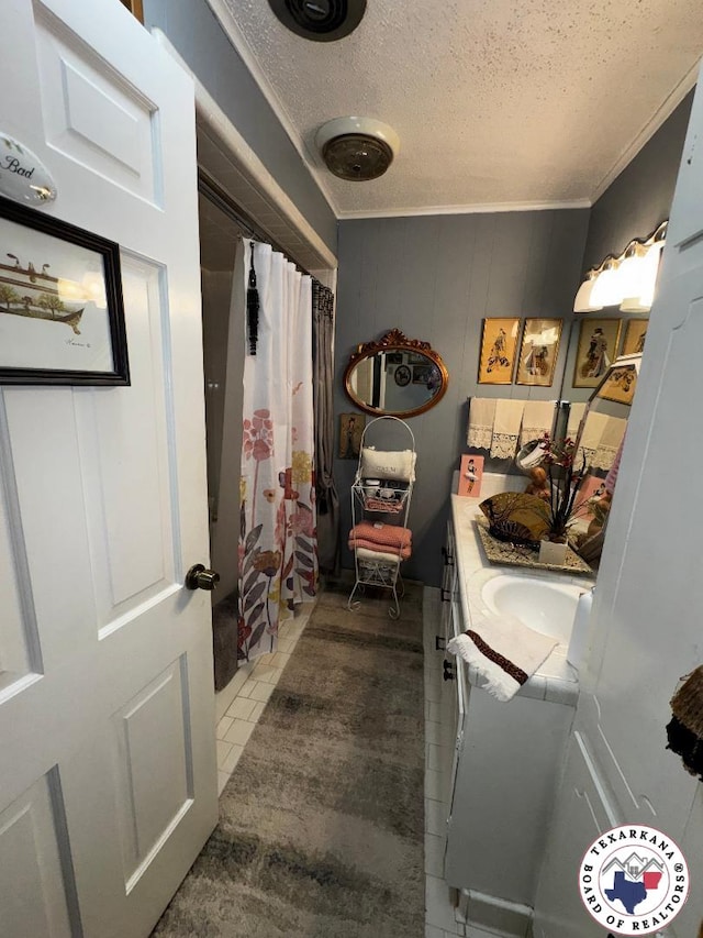 1509 W 40th St, Texarkana, TX 75503 - bathroom with vanity, a textured ceiling, a shower with shower curtain, crown molding, and tile patterned flooring