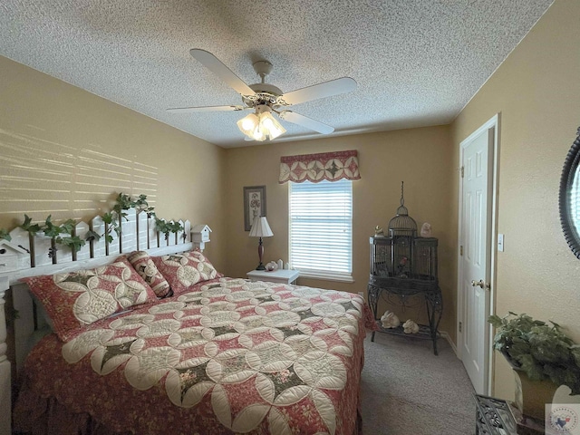 carpeted bedroom with ceiling fan and a textured ceiling