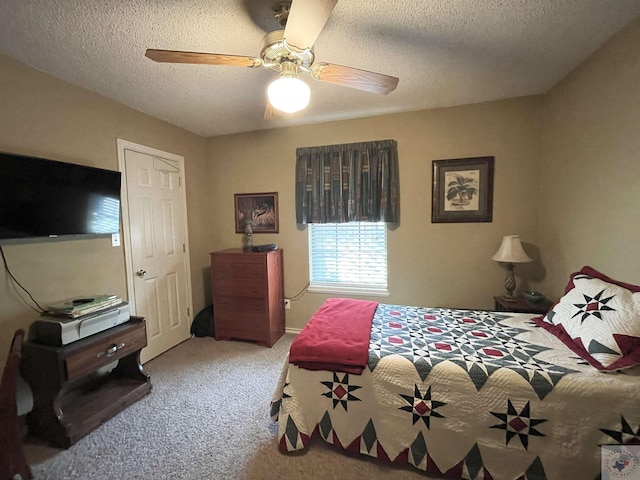 carpeted bedroom featuring ceiling fan and a textured ceiling