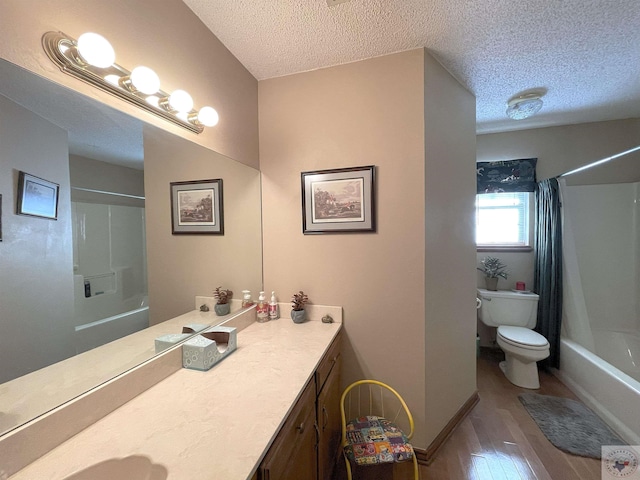 full bathroom with hardwood / wood-style flooring, toilet, a textured ceiling, vanity, and shower / bathtub combination with curtain