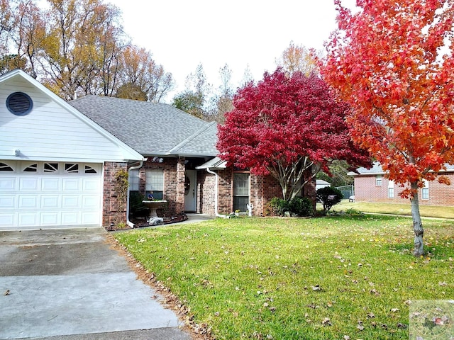 view of front of property with a garage and a front lawn