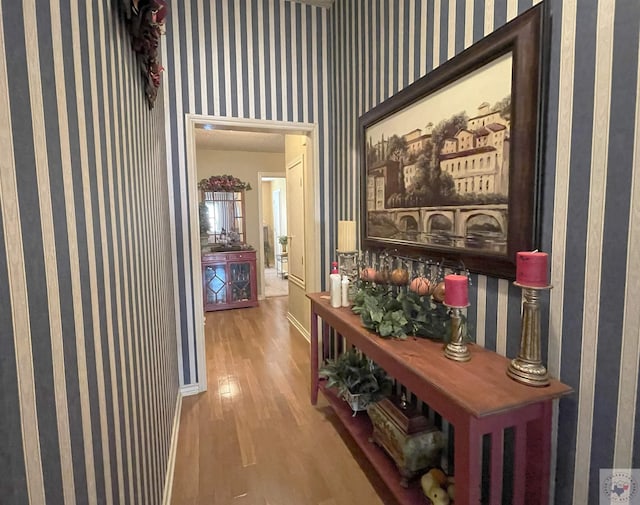 hallway with hardwood / wood-style floors