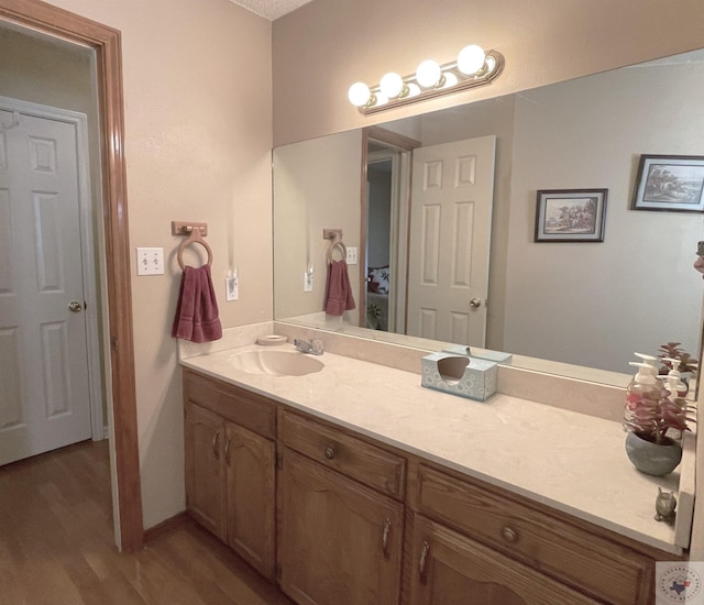 bathroom with vanity and hardwood / wood-style floors