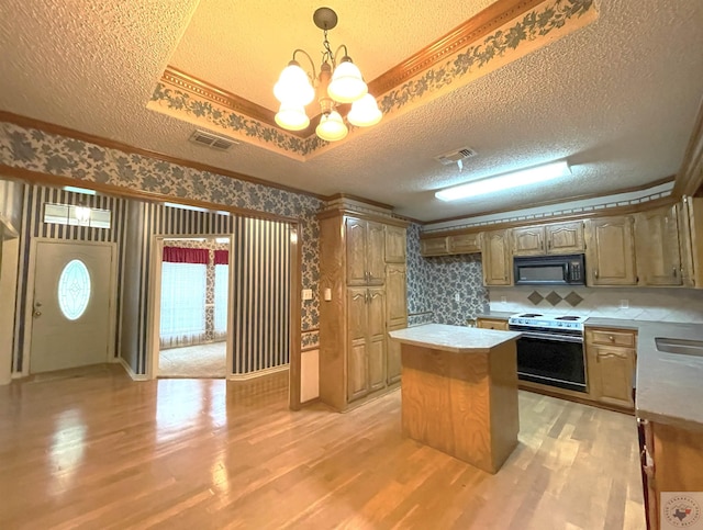 130 Westline Rd, Wake Village, TX 75501 - kitchen featuring range with electric stovetop, black microwave, light wood-style floors, a textured ceiling, and a chandelier