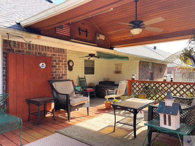 view of patio / terrace with an outdoor living space, ceiling fan, and a deck