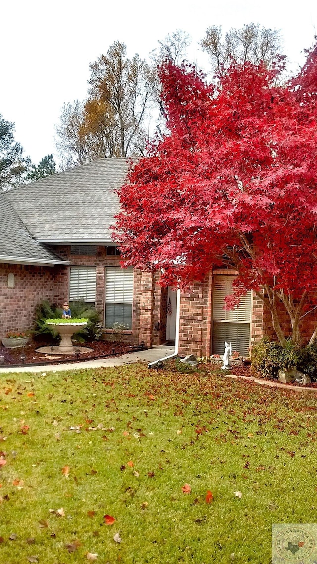 exterior space featuring a garage and a front yard