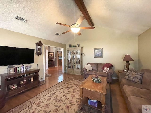 living room with ceiling fan, beam ceiling, high vaulted ceiling, and a textured ceiling