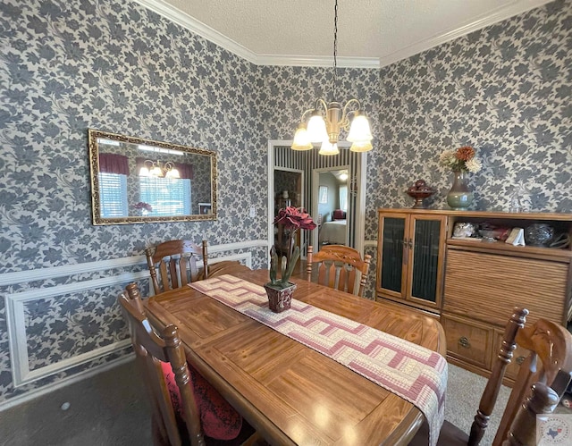 dining area featuring a notable chandelier, ornamental molding, and a textured ceiling