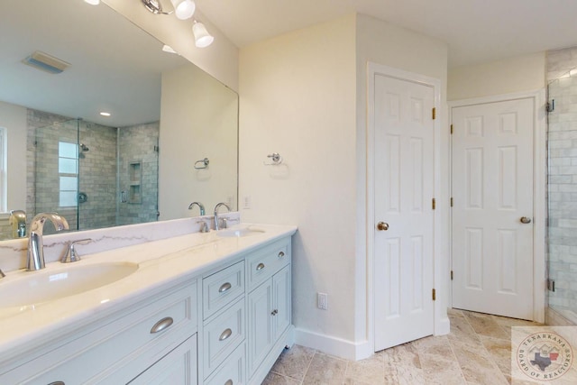 bathroom with a shower with door and vanity