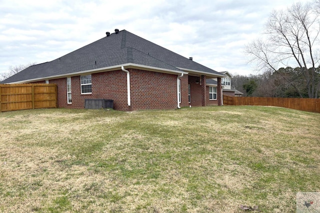 back of house with a lawn