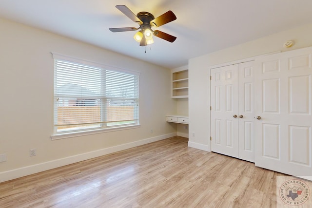 unfurnished bedroom with light hardwood / wood-style flooring, a closet, and ceiling fan