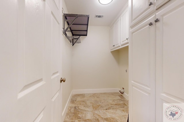 laundry area with cabinets