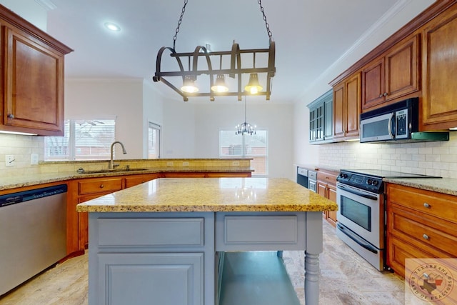 kitchen featuring light stone counters, sink, stainless steel appliances, and a kitchen island