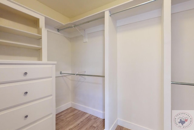 walk in closet featuring light hardwood / wood-style flooring