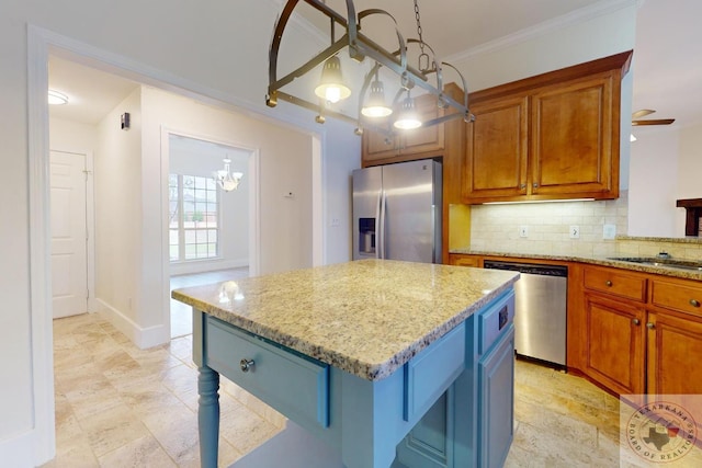 kitchen featuring a center island, stainless steel appliances, tasteful backsplash, light stone counters, and crown molding