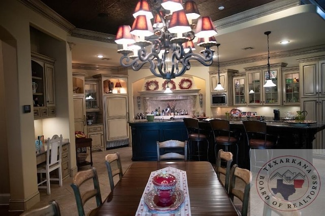 dining room with a notable chandelier and crown molding