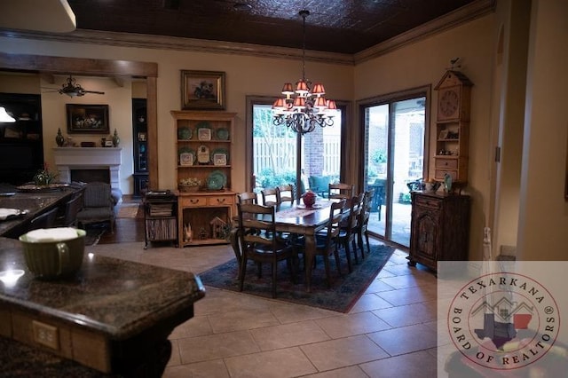 dining area featuring ceiling fan with notable chandelier, crown molding, and light tile patterned floors