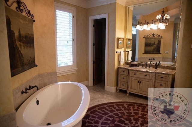 bathroom featuring a tub to relax in, an inviting chandelier, and vanity