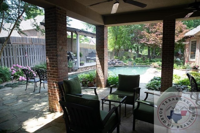 view of patio featuring ceiling fan and a fenced in pool