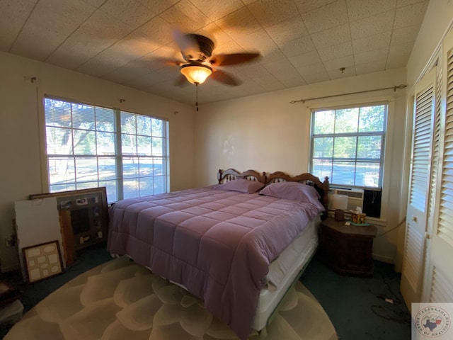 carpeted bedroom with ceiling fan and cooling unit