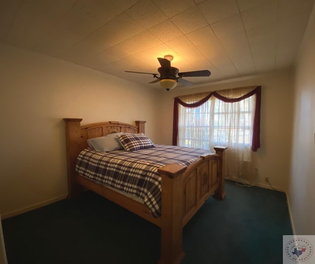 bedroom with dark colored carpet and ceiling fan