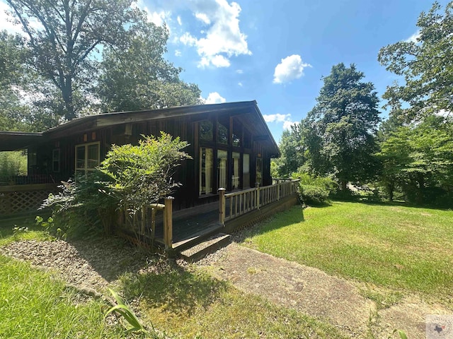 view of side of property with a yard